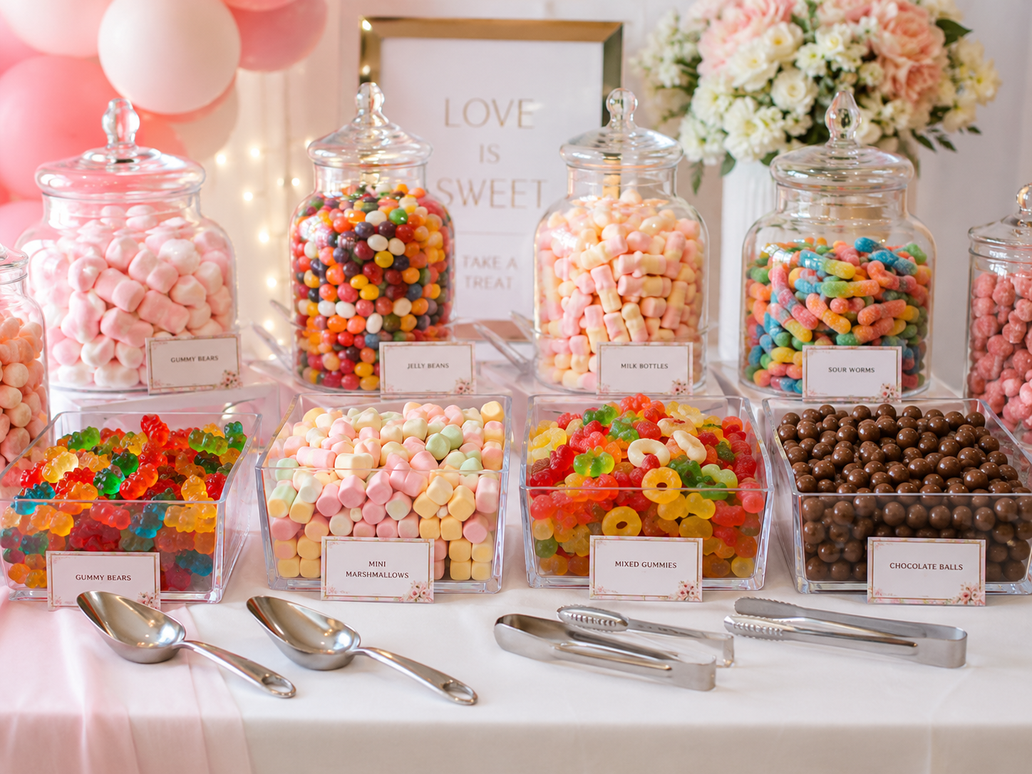 Glass jars and acrylic containers filled with lollies for a styled candy buffet table